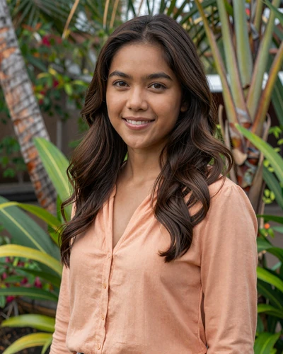 Filipina woman Celeste from Cebu smiling in a peach blouse near a tropical garden