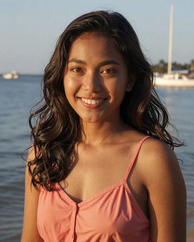 Indonesian woman Putri from Jakarta in a coral sundress near a waterfront