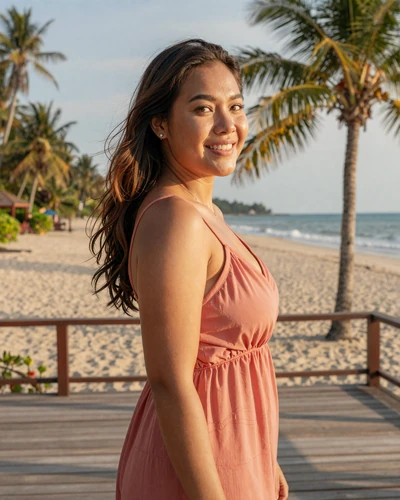 Thai woman Dara from Phuket on a tropical beach deck at golden hour